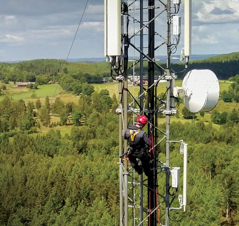 Workers are climbing to repair the telecommunication tower or poles, in the evening,Red sky sunset background